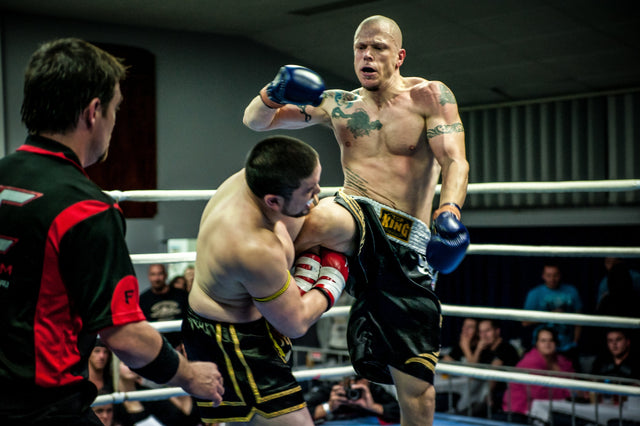 Combat sports athletes competing in a ring