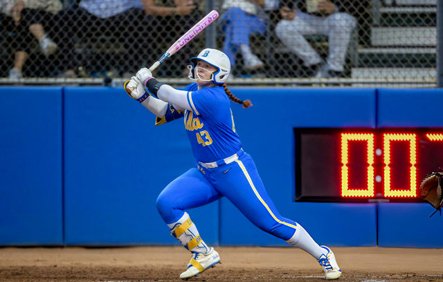 Softball player following through on a swing