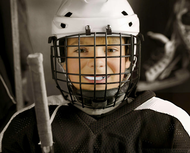 Young hockey player smiling with a mouthguard